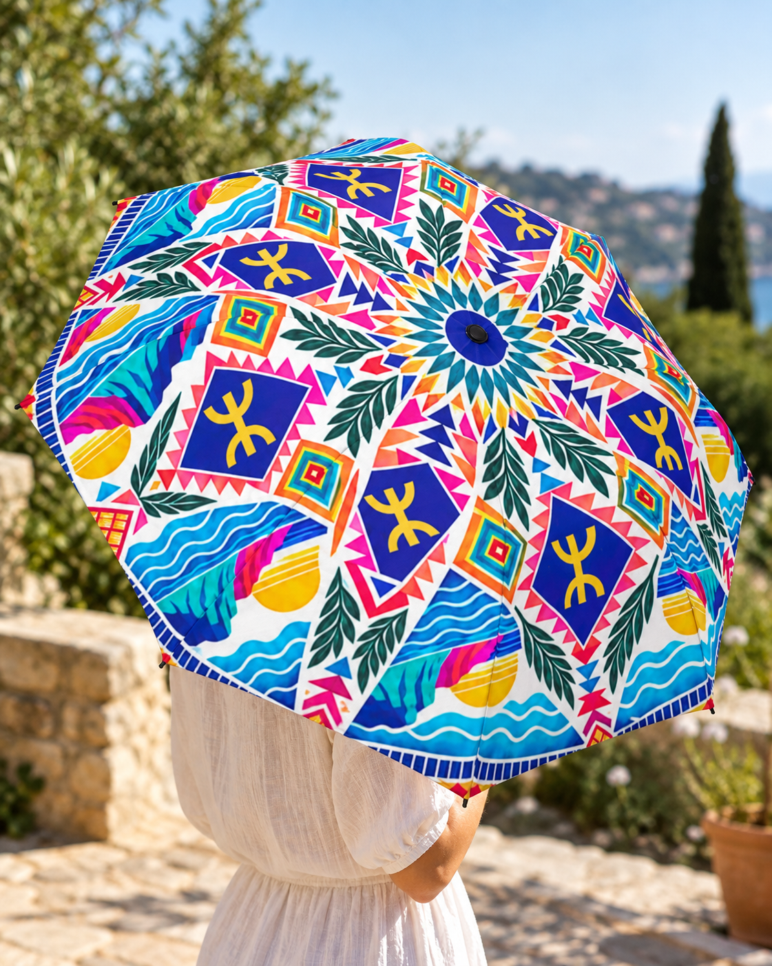Open Amagomera umbrella with colorful geometric and botanical canopy artwork